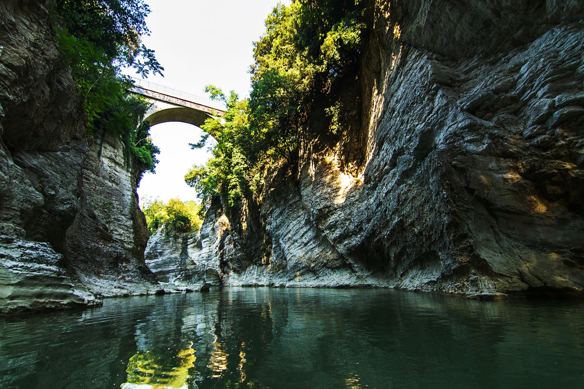 Ponte nell'area delle Marmitte dei Giganti con canoa sul fiume